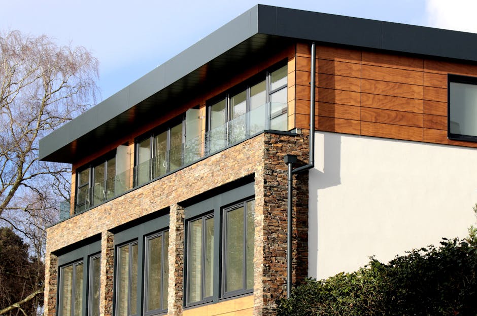 Contemporary house in Poole featuring a striking mix of stone and wood facade with large windows